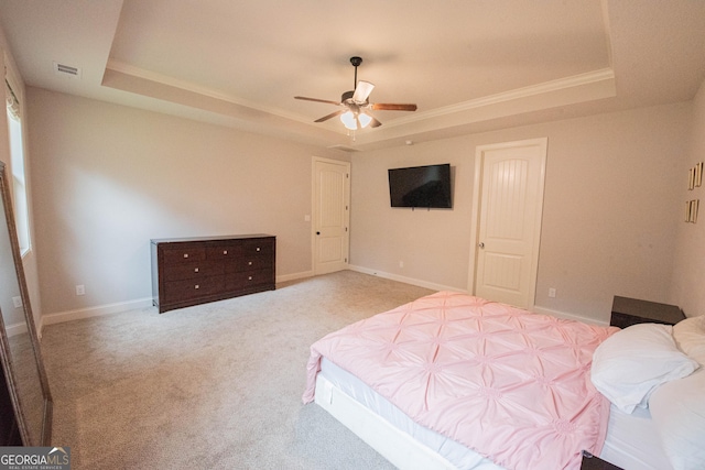 bedroom with visible vents, baseboards, a tray ceiling, and carpet floors