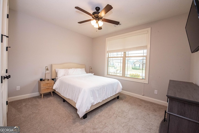 carpeted bedroom featuring a ceiling fan, baseboards, and visible vents