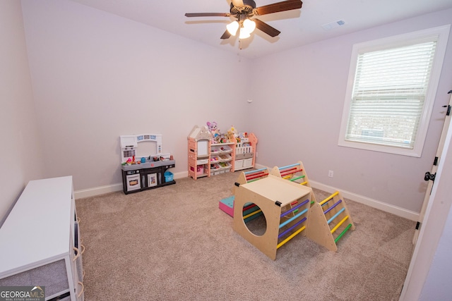 recreation room featuring visible vents, baseboards, carpet, and a ceiling fan