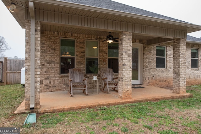 view of patio featuring ceiling fan and fence