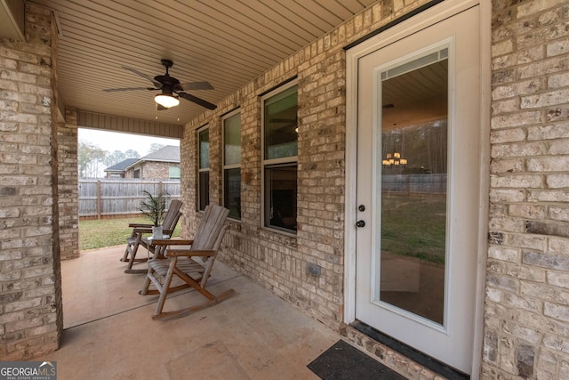 view of patio with a ceiling fan and fence