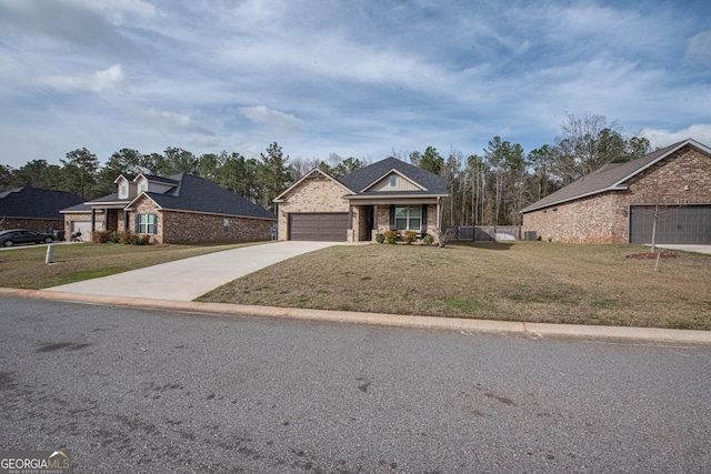 traditional-style house featuring concrete driveway, fence, and a front lawn