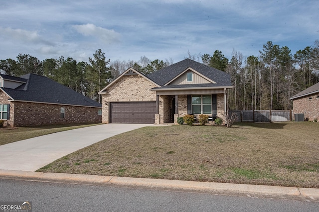 view of front of home with brick siding, a garage, driveway, and a front yard