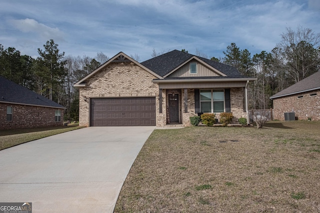 view of front of property featuring concrete driveway, a garage, and a front yard