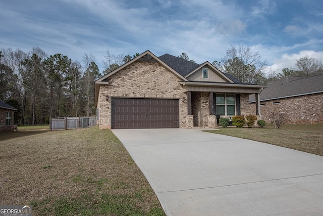 craftsman-style house featuring brick siding, a garage, driveway, and a front lawn
