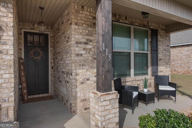 doorway to property with covered porch and stone siding