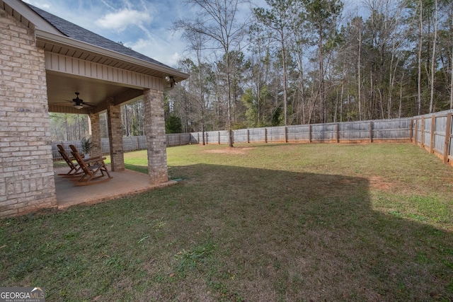 view of yard featuring a patio, a fenced backyard, and a ceiling fan