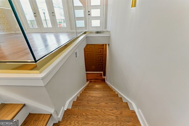 staircase featuring visible vents and wood finished floors