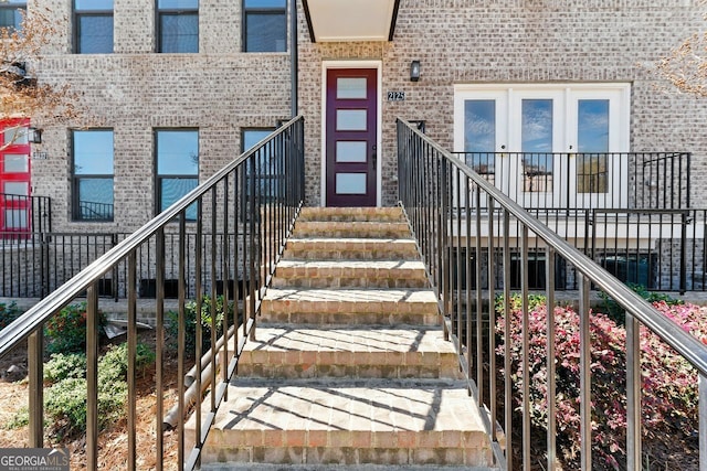 doorway to property featuring brick siding