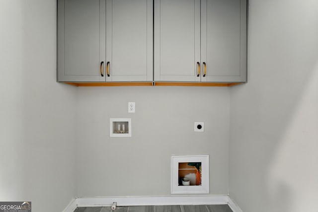 laundry area featuring baseboards, cabinet space, hookup for an electric dryer, and hookup for a washing machine