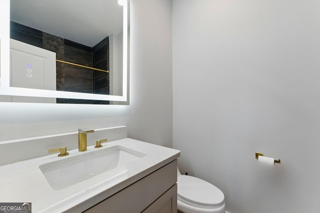 bathroom with toilet and vanity