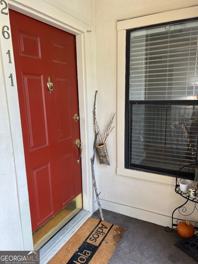 doorway to property with stucco siding
