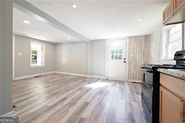 6886 Upshaw Mill Rd, Douglasville, GA 30134 - kitchen with black range with electric stovetop, a textured ceiling, light wood finished floors, baseboards, and recessed lighting