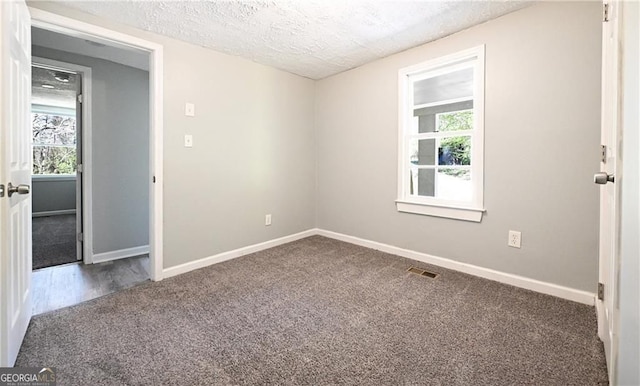 6886 Upshaw Mill Rd, Douglasville, GA 30134 - spare room featuring carpet, a textured ceiling, and baseboards