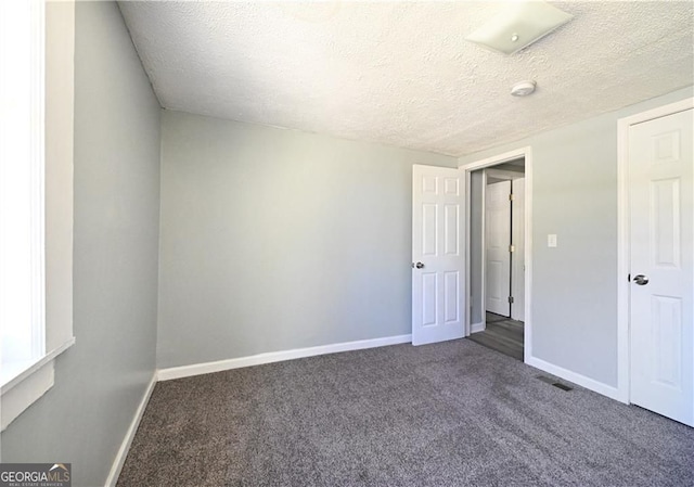 6886 Upshaw Mill Rd, Douglasville, GA 30134 - unfurnished bedroom featuring carpet flooring, baseboards, and a textured ceiling