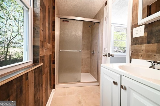 6886 Upshaw Mill Rd, Douglasville, GA 30134 - full bathroom with a stall shower, a textured ceiling, vanity, and tile patterned floors