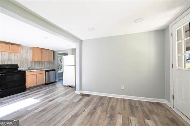 6886 Upshaw Mill Rd, Douglasville, GA 30134 - kitchen featuring black electric range, freestanding refrigerator, stainless steel dishwasher, light wood-type flooring, and baseboards