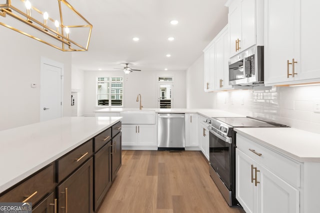 2219 Nena Way Unit 22, Tucker, GA 30084 - kitchen with ceiling fan, light countertops, decorative backsplash, appliances with stainless steel finishes, and a sink