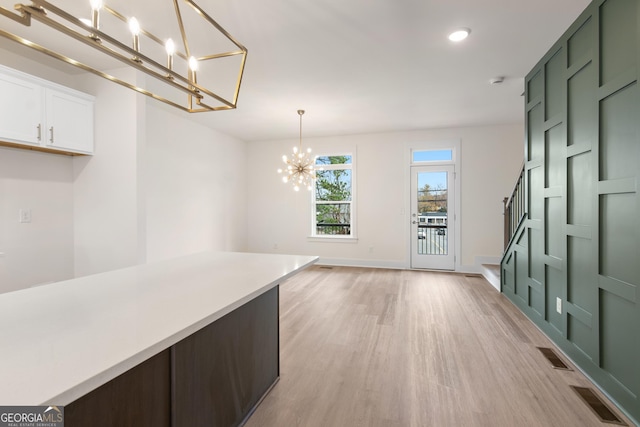 2219 Nena Way Unit 22, Tucker, GA 30084 - unfurnished dining area with visible vents, baseboards, a chandelier, and light wood-style flooring