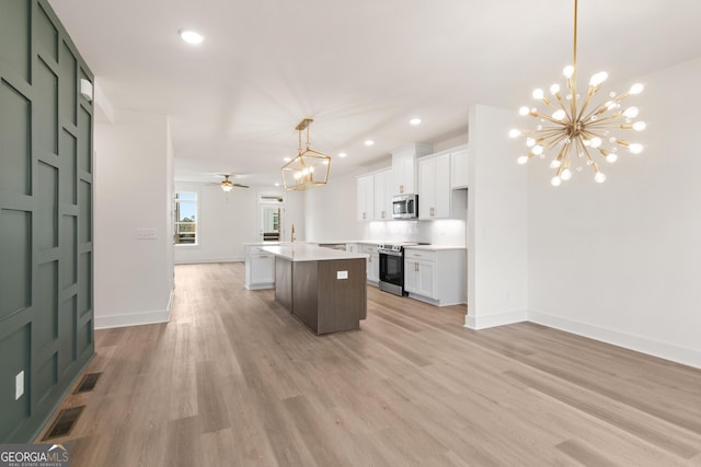 2219 Nena Way Unit 22, Tucker, GA 30084 - kitchen with visible vents, open floor plan, a center island, appliances with stainless steel finishes, and white cabinets