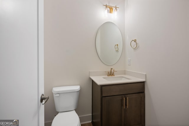 2219 Nena Way Unit 22, Tucker, GA 30084 - half bathroom featuring vanity, toilet, and baseboards
