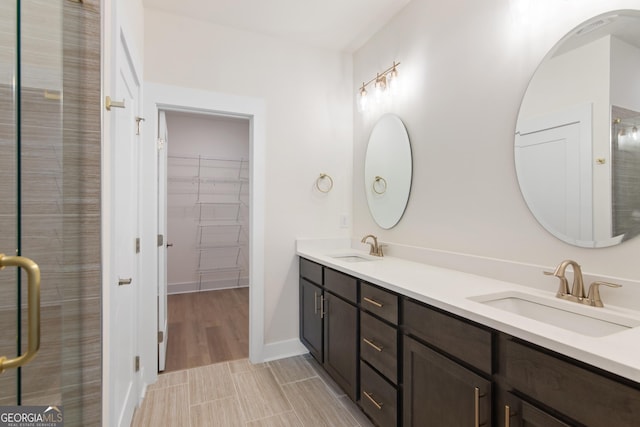 2219 Nena Way Unit 22, Tucker, GA 30084 - full bath with double vanity, a stall shower, a walk in closet, and a sink