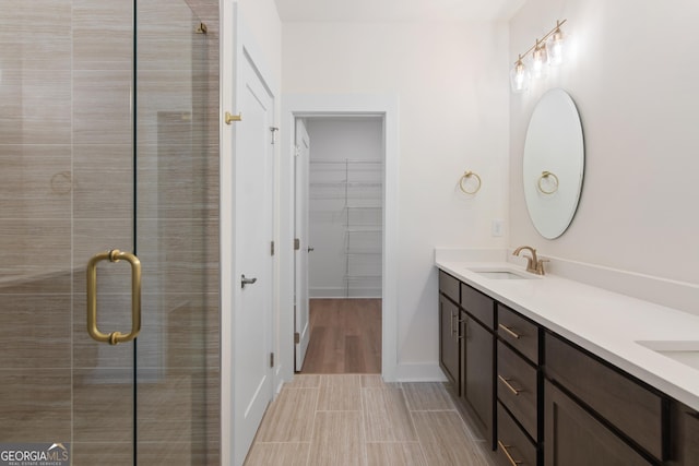 2219 Nena Way Unit 22, Tucker, GA 30084 - full bathroom featuring a walk in closet, a stall shower, a sink, double vanity, and baseboards