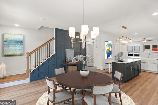 2219 Nena Way Unit 22, Tucker, GA 30084 - dining room featuring light wood finished floors, baseboards, stairway, recessed lighting, and ceiling fan with notable chandelier