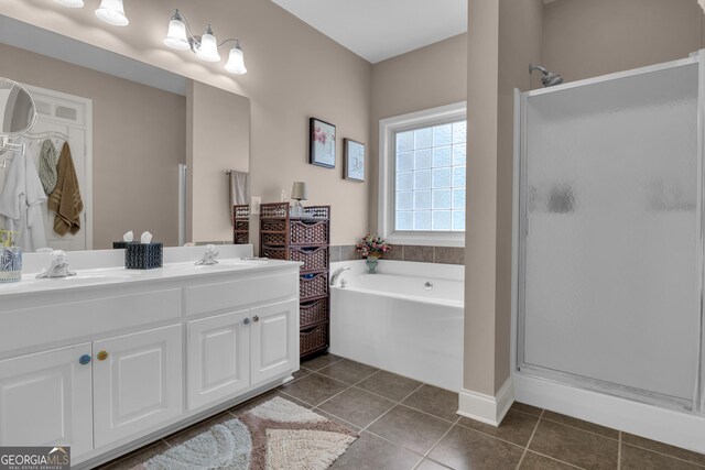 bathroom with a shower stall and tile patterned flooring