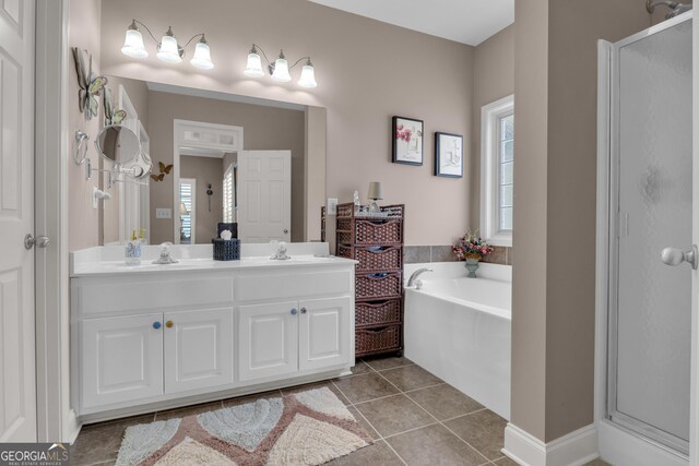bathroom featuring plenty of natural light, tile patterned flooring, and a stall shower