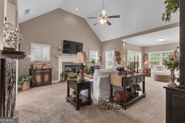 living room with carpet flooring, a fireplace, ceiling fan, and high vaulted ceiling