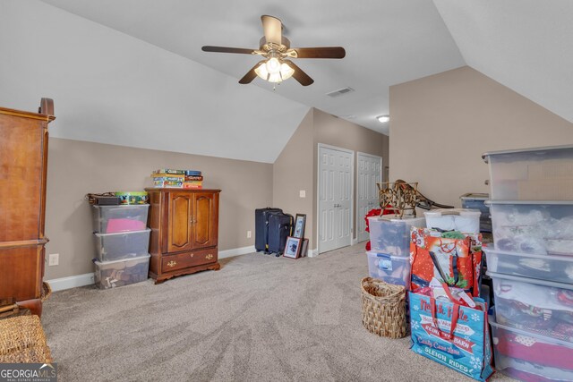 recreation room with vaulted ceiling, a ceiling fan, carpet flooring, and baseboards