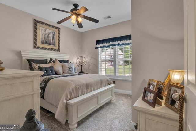bedroom with baseboards, light carpet, and a ceiling fan