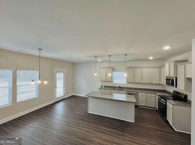 61 Observation Way, Dallas, GA 30132 - kitchen featuring appliances with stainless steel finishes, dark wood finished floors, recessed lighting, a kitchen island, and baseboards