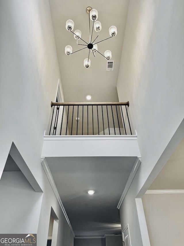 61 Observation Way, Dallas, GA 30132 - stairway featuring a towering ceiling, a chandelier, and crown molding