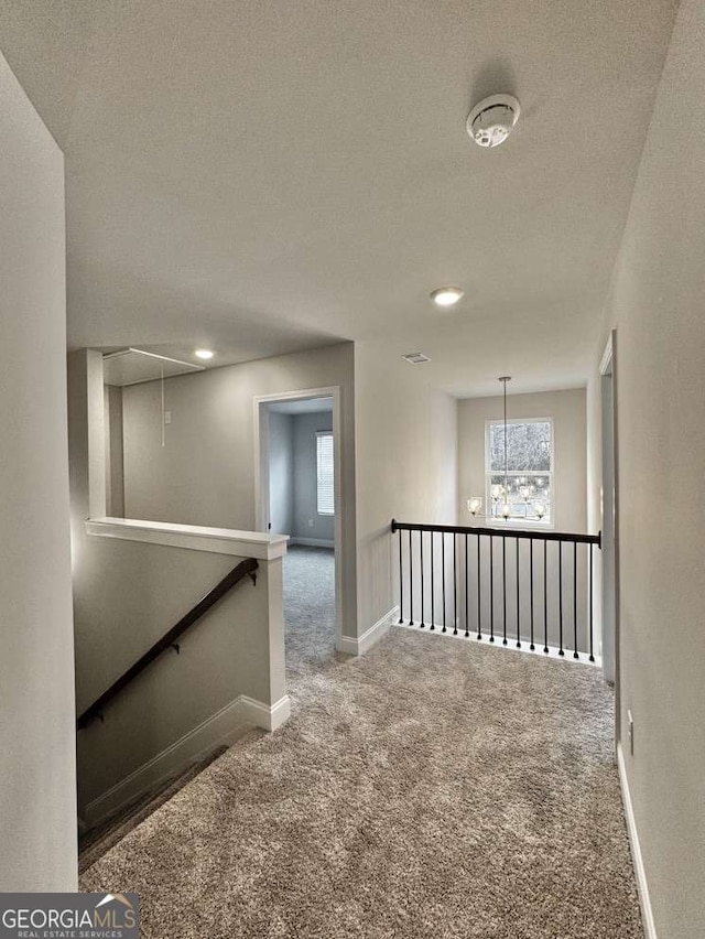 61 Observation Way, Dallas, GA 30132 - hall with an upstairs landing, attic access, carpet, healthy amount of natural light, and a textured ceiling