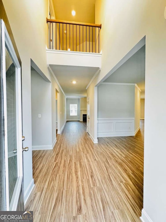 61 Observation Way, Dallas, GA 30132 - entrance foyer featuring a high ceiling, ornamental molding, wood finished floors, a fireplace, and baseboards