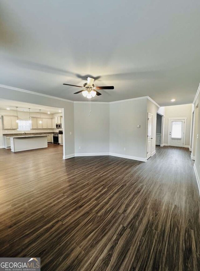 61 Observation Way, Dallas, GA 30132 - unfurnished living room featuring dark wood-style floors, baseboards, crown molding, ceiling fan, and recessed lighting