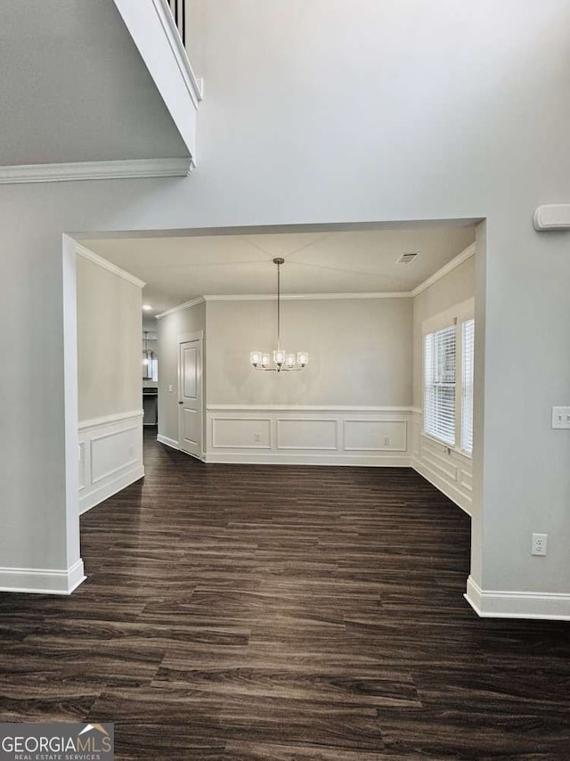 61 Observation Way, Dallas, GA 30132 - unfurnished dining area with ornamental molding, a chandelier, dark wood-type flooring, a decorative wall, and wainscoting