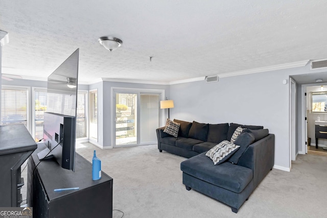 carpeted living room with plenty of natural light, baseboards, visible vents, and ornamental molding
