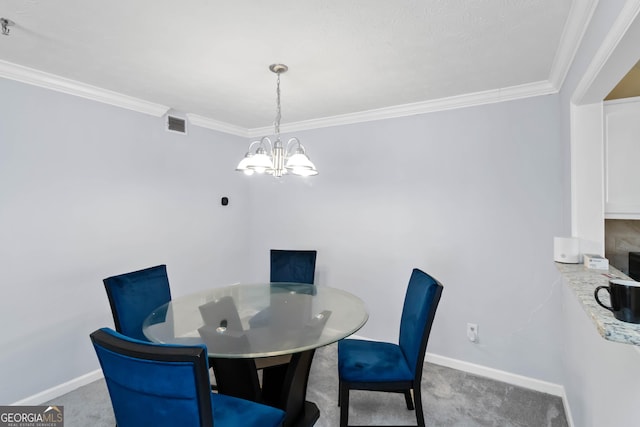 dining room with a chandelier, carpet flooring, crown molding, and baseboards