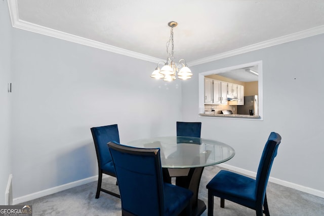 dining space with a chandelier, crown molding, baseboards, and light carpet