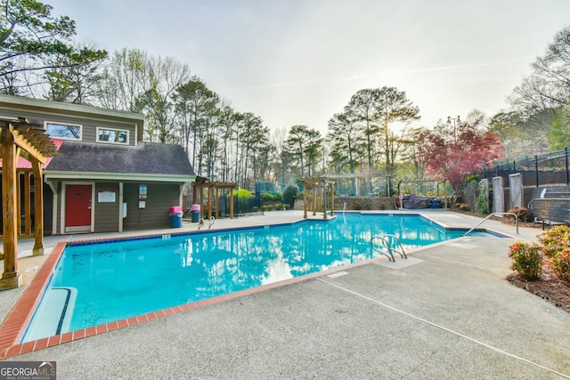 community pool featuring fence, a patio, and a pergola