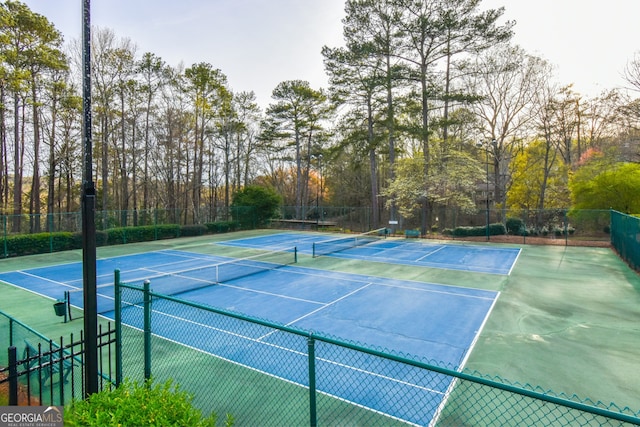 view of tennis court with fence
