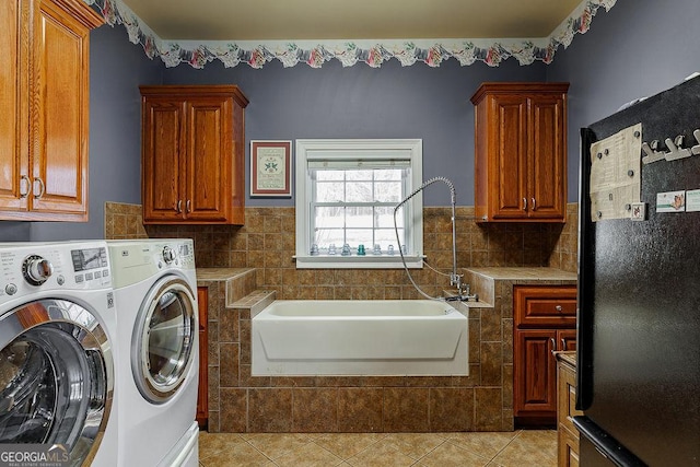 36 Blackthorn Ln, Colbert, GA 30628 - laundry area with separate washer and dryer, cabinet space, light tile patterned floors, and tile walls