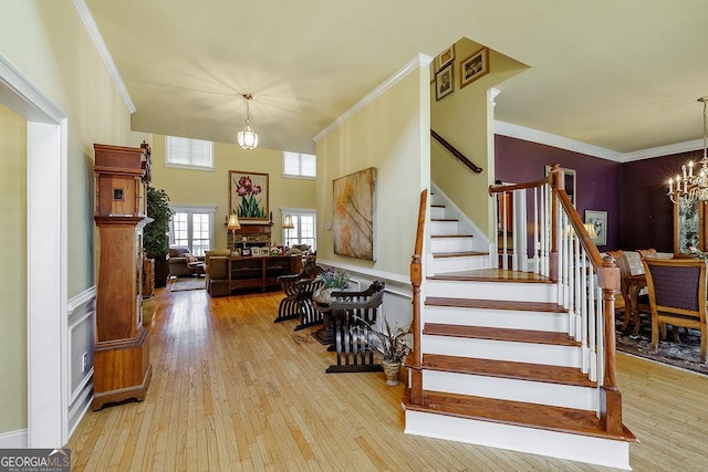 36 Blackthorn Ln, Colbert, GA 30628 - stairway featuring a chandelier, wood finished floors, ornamental molding, and a wainscoted wall