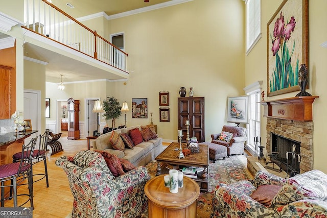 36 Blackthorn Ln, Colbert, GA 30628 - living room featuring a towering ceiling, ornamental molding, wood finished floors, and a fireplace