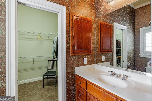 36 Blackthorn Ln, Colbert, GA 30628 - bathroom featuring tile patterned floors, vanity, a walk in closet, crown molding, and baseboards