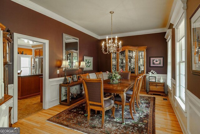 36 Blackthorn Ln, Colbert, GA 30628 - dining area with plenty of natural light, a chandelier, a wainscoted wall, light wood finished floors, and crown molding