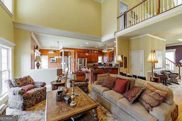 36 Blackthorn Ln, Colbert, GA 30628 - living room with a towering ceiling, crown molding, a chandelier, wood finished floors, and ceiling fan